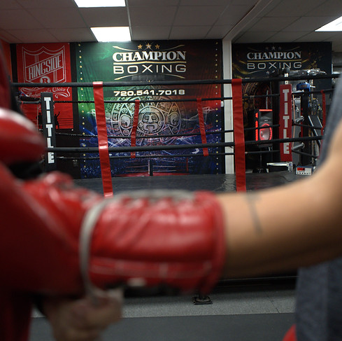 Ring-side view of boxing gloves at Champion Boxing